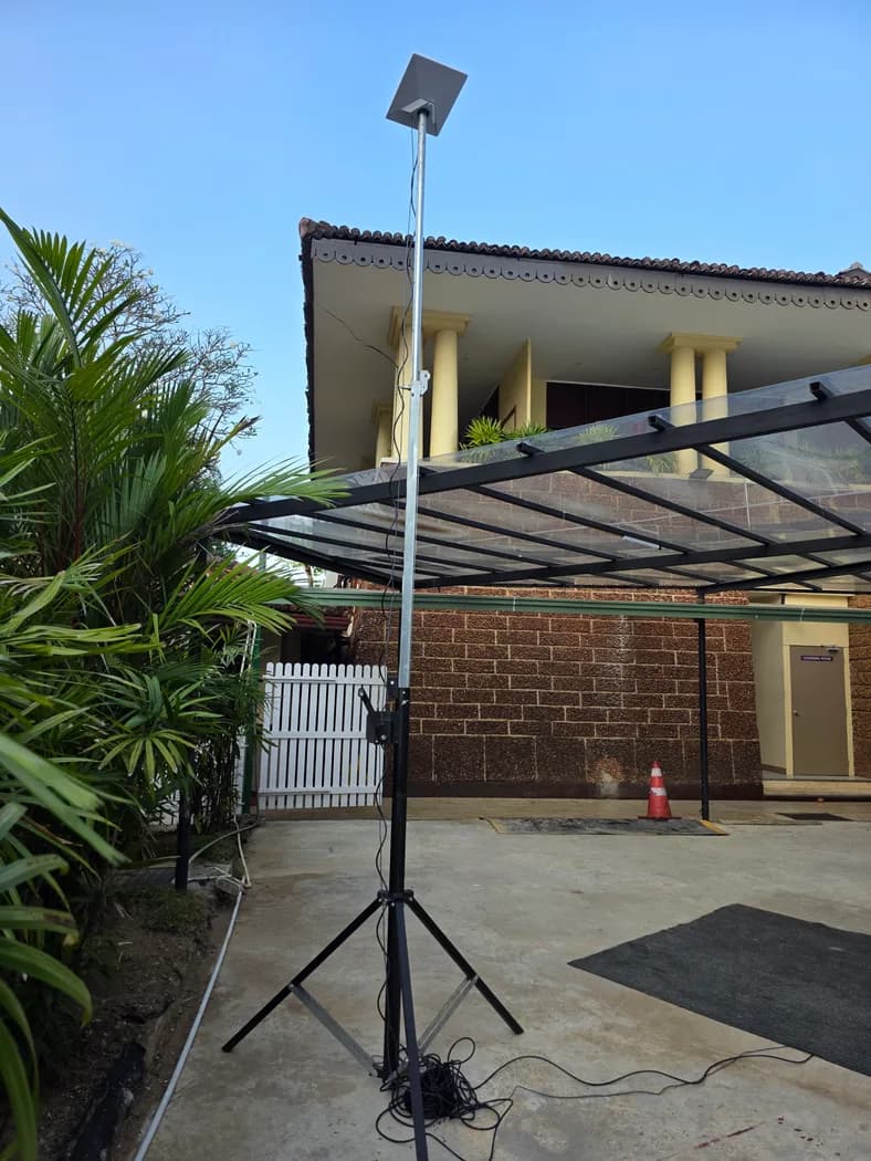 Starlink Mini dish mounted on a telescopic tripod mast, deployed at a Colombo venue carport