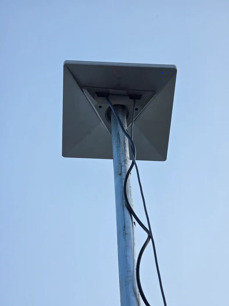 Close-up of the Starlink Mini dish mounted on the pole, front face