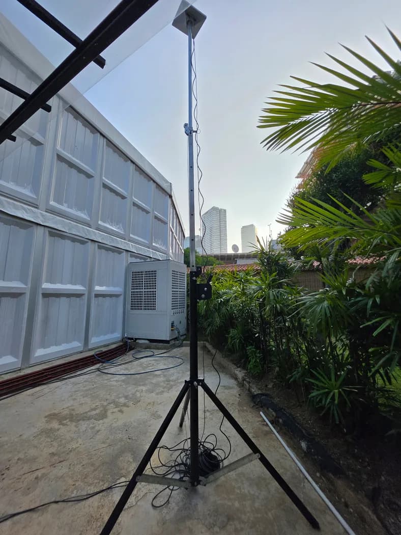 Starlink Mini tripod deployment on a rooftop terrace with skyline view — real rental photo 7