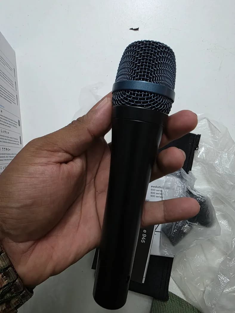 Sennheiser e945 dynamic vocal microphone, front angle with box and clip — real rental photo 2